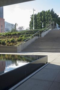 there are steps leading up to the water feature and a sculpture next to it,