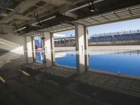Concrete Road with Building and Water Reflection