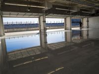 Concrete Road with Building and Water Reflection