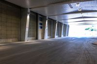 the large empty parking garage has lots of concrete walls and flooring with low ceilings