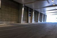 the large empty parking garage has lots of concrete walls and flooring with low ceilings