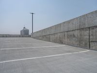 a parking lot and wall are pictured in a photo from the perspective point of view