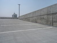 a parking lot and wall are pictured in a photo from the perspective point of view