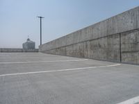 a parking lot and wall are pictured in a photo from the perspective point of view