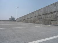 a parking lot and wall are pictured in a photo from the perspective point of view