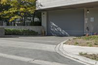 a gray garage is shown with its doors open and a fire hydrant in the driveway
