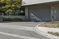 a gray garage is shown with its doors open and a fire hydrant in the driveway