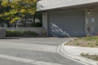 a gray garage is shown with its doors open and a fire hydrant in the driveway