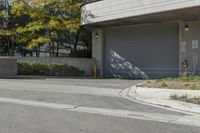 a gray garage is shown with its doors open and a fire hydrant in the driveway