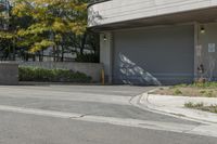 a gray garage is shown with its doors open and a fire hydrant in the driveway