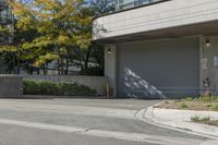 a gray garage is shown with its doors open and a fire hydrant in the driveway