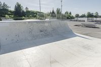 a concrete park with skateboards and benches is shown in this image, but at one time it was empty