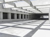 concrete and steel structure with low shadows, in an open parking lot, with empty spaces for cars and pedestrians