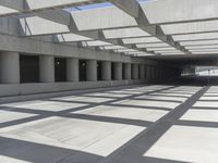 concrete and steel structure with low shadows, in an open parking lot, with empty spaces for cars and pedestrians