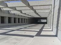 concrete and steel structure with low shadows, in an open parking lot, with empty spaces for cars and pedestrians