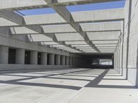 concrete and steel structure with low shadows, in an open parking lot, with empty spaces for cars and pedestrians