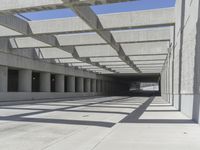 concrete and steel structure with low shadows, in an open parking lot, with empty spaces for cars and pedestrians