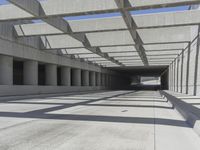 concrete and steel structure with low shadows, in an open parking lot, with empty spaces for cars and pedestrians