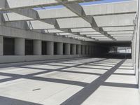 concrete and steel structure with low shadows, in an open parking lot, with empty spaces for cars and pedestrians