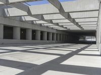 concrete and steel structure with low shadows, in an open parking lot, with empty spaces for cars and pedestrians