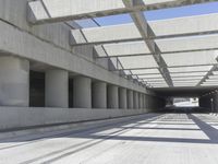 concrete and steel structure with low shadows, in an open parking lot, with empty spaces for cars and pedestrians