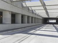 concrete and steel structure with low shadows, in an open parking lot, with empty spaces for cars and pedestrians