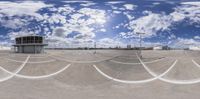 a 360 camera image showing the reflection of clouds and blue sky in a skateboard park