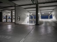 a dimly lit parking garage, showing the ground, ceiling and lights in it, all by itself