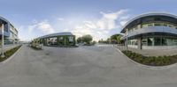 the 360 - ball panorama image shows an office building and a parking lot with buildings in the background