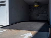 a gray walkway leading up to a building next to a yellow light lantern on top