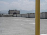 a parking lot and wall are pictured in a photo from the perspective point of view