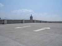 a parking lot and wall are pictured in a photo from the perspective point of view