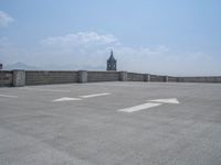 a parking lot and wall are pictured in a photo from the perspective point of view