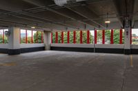 empty parking garage with lots of windows and red and white decor on the side wall