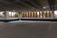 empty parking garage with lots of windows and red and white decor on the side wall