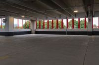 empty parking garage with lots of windows and red and white decor on the side wall