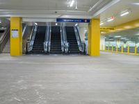 an empty parking garage with the escalators closed and several stairs inside it at a mall