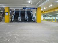 an empty parking garage with the escalators closed and several stairs inside it at a mall