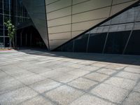 a close up image of a concrete wall outside a building and trees near by and on side