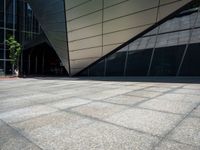 a close up image of a concrete wall outside a building and trees near by and on side