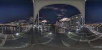 three panoramic images of the buildings at night and a street below them in a mirror