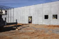 a cement wall being constructed and covered with a flatbed trailer in front of it