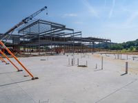 a building being built with concrete and steel frameworks on the outside ground on a sunny day