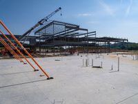 a building being built with concrete and steel frameworks on the outside ground on a sunny day