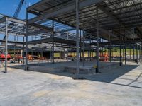 an industrial building under construction with people in the background by it's roof trussing