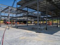 an industrial building under construction with people in the background by it's roof trussing