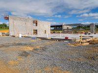 the construction site has been built with materials for some concrete and wood work, like some other building material, and lots of steel