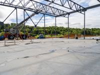 a crane is holding in the beam while working on a roofing slab under construction