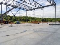 a crane is holding in the beam while working on a roofing slab under construction