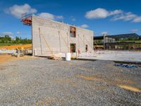 the cement structure on the construction site is under construction in the daytime or afternoon sky